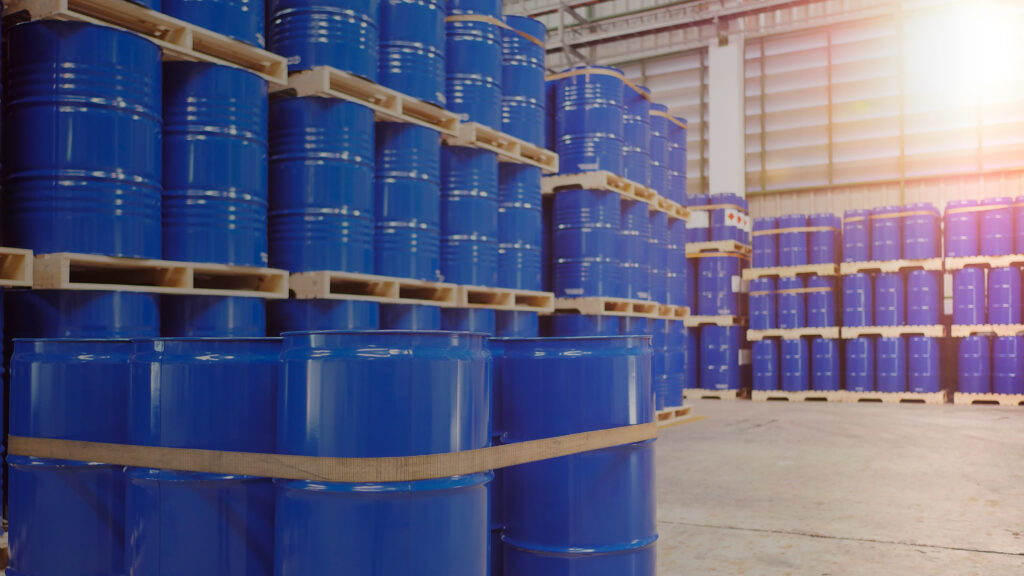 Steel drums used for hazardous materials safely stored in a warehouse.