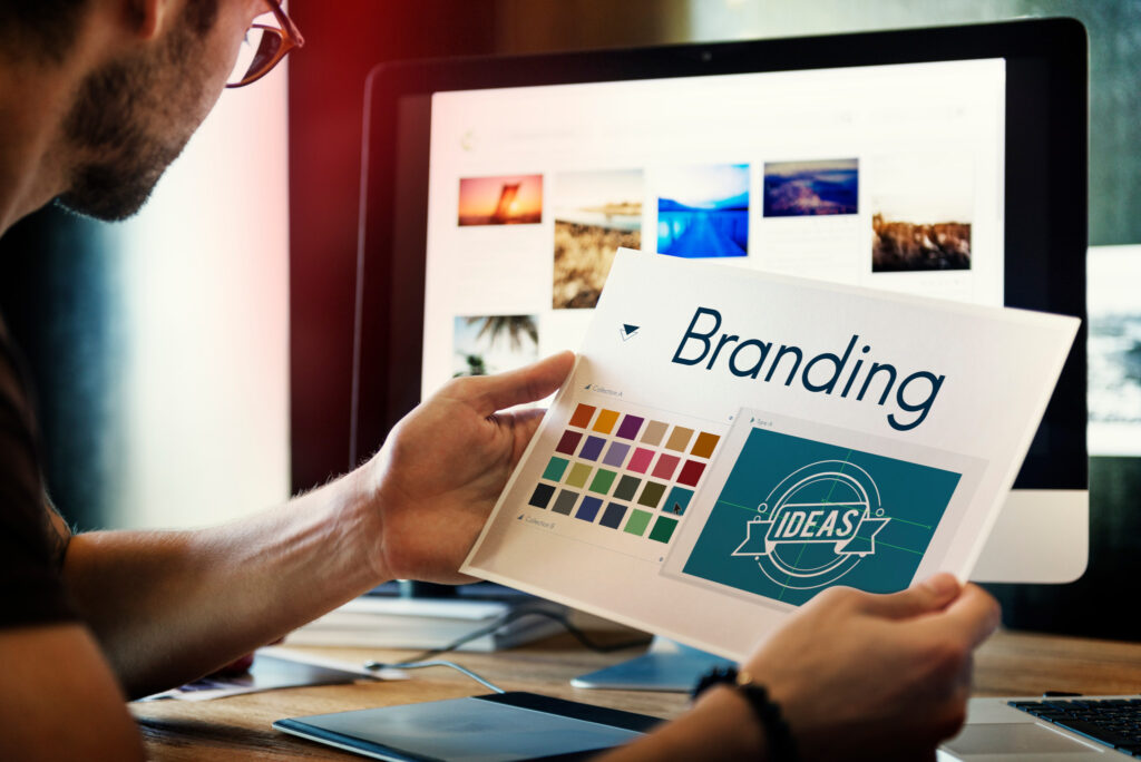 A man looking at a branding style sheet related to packaging development.
